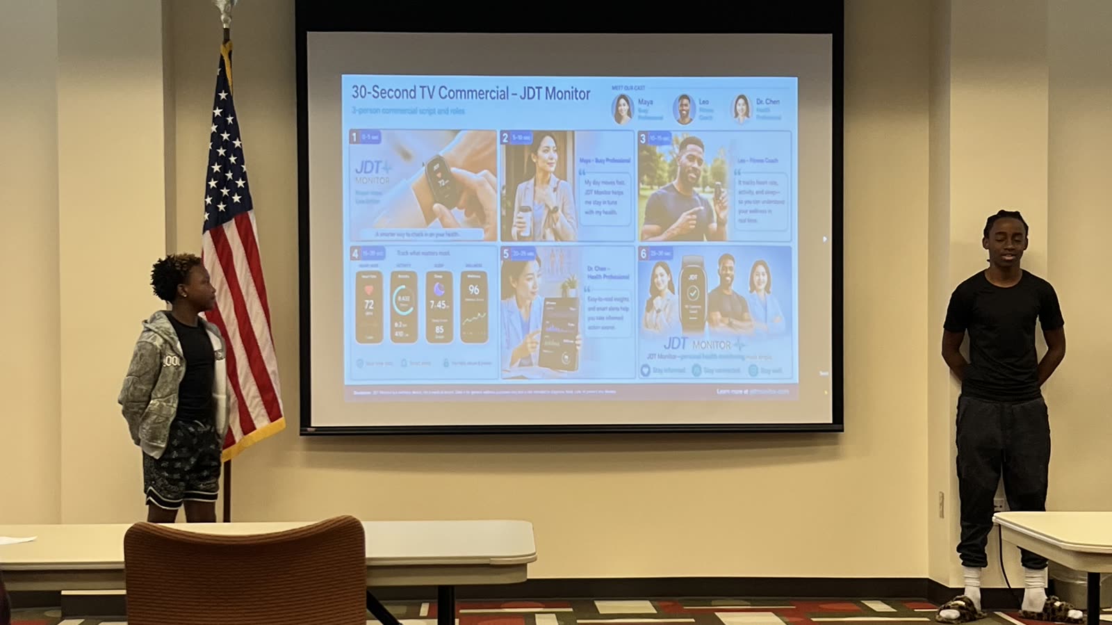 Students presenting a 30 second TV commercial for a product they invented, projected on the screen